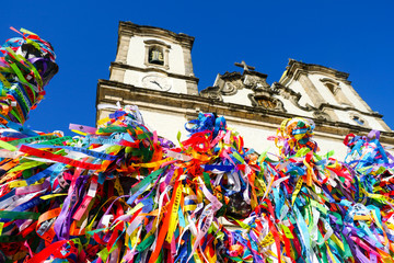 Igreja de Nosso Senhor do Bonfim, a catholic church located in Salvador, Bahia in Brazil. Famous touristic place where people make wishes while tie the ribbons in front of the church. - obrazy, fototapety, plakaty