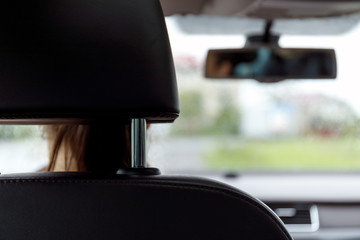 Driver's side road travel view with rearview mirror.