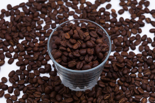 Coffee beans with a glass