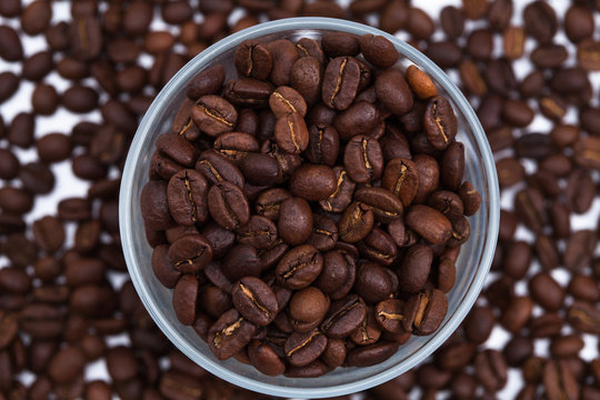 Coffee beans with a glass