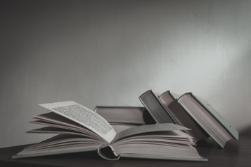 Stack of old history books lying on the desk waiting to be studied.