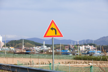 Triangle road sign left turn in south korea countryside