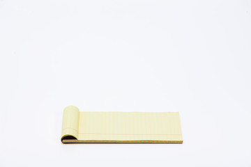 Yellow pencil on lined note paper isolated