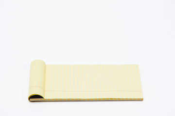 Yellow pencil on lined note paper isolated