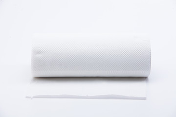 Fototapeta premium Roll of disposable nonwoven fabric towels isolated