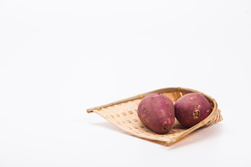 Red sweet potato in a bamboo winnow basket