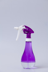 PurPle plastic bottle of spray on gray