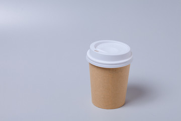 Take away disposable coffee cup on gray background
