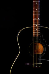 Fototapeta na wymiar musical instrument wood acoustic six-string guitar isolated on blackbackground
