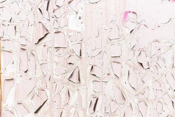 Pink and white cracked paint surface