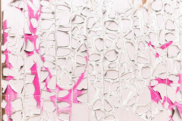 Pink and white cracked paint surface