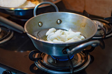 Frying snacks indian way in hot oil and pan