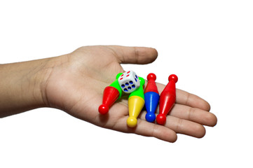 Pawns and dice in hand and on the fore fingers