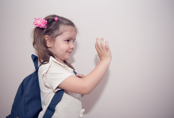 Cute girl going to school with backpack. Education concept. Isolated.