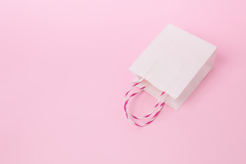 Stand white eco craft shopping bag with handles on pink background