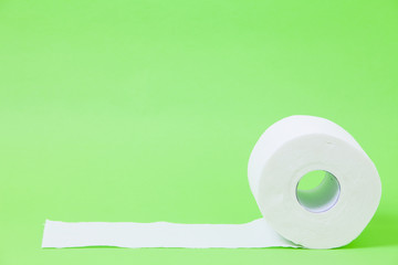 The roll of white toilet eco tissue paper on green background 