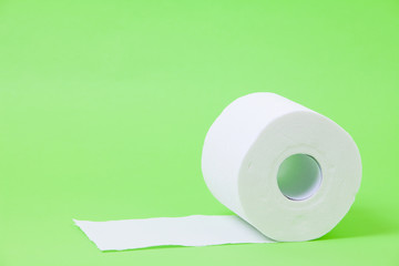 The roll of white toilet eco tissue paper on green background 