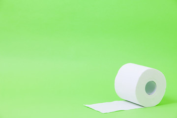The roll of white toilet eco tissue paper on green background 