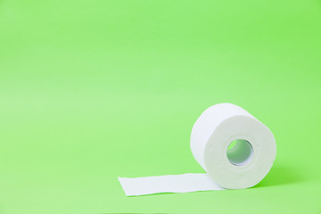 The roll of white toilet eco tissue paper on green background 