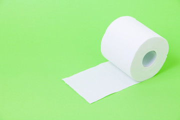 The roll of white toilet eco tissue paper on green background 