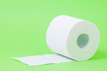 The roll of white toilet eco tissue paper on green background 