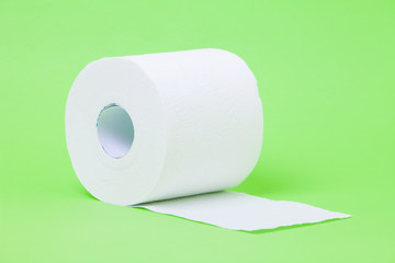 The roll of white toilet eco tissue paper on green background 