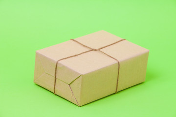  Brown eco kraft gift wrapped box on green background