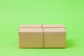  Brown eco kraft gift wrapped box on green background