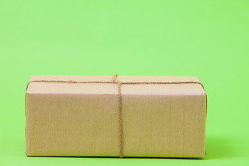  Brown eco kraft gift wrapped box on green background