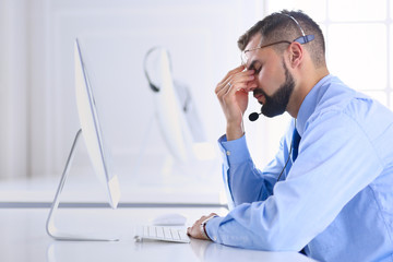 Businessman in the office on the phone with headset, Skype, FaceTime