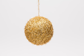 Hanging holiday christmas ball of Gold isolated on white with yellow sticker 