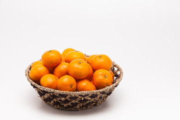 Ornage in basket isolated on white background Mandarin