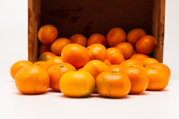 Mandarin  tangerine in wooden crate isolated on white