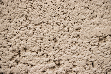 Beige stucco wall texture close up
