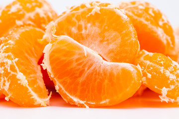 Peeled mandarin oranges on white background 