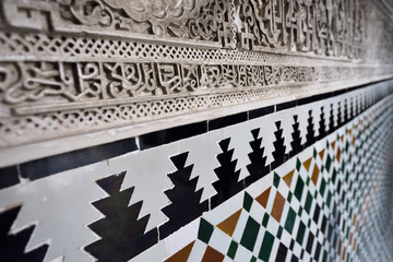 Close up of arabic wall carving and tilework at Alcazar palace Seville Andalusia