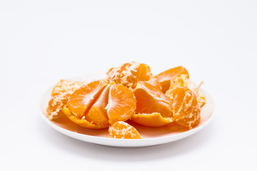 Peeled mandarin orange in white dish 