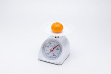 Healthy mandarin oranges on balance scale