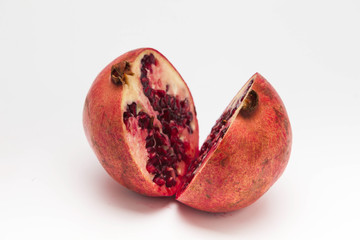 Pomegranate cut in halves over white