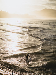 Surfer getting in the water in San Sebastian