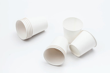 White paper cup and cups on white backbround