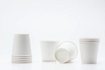 White paper cup and cups on white backbround