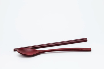Wooden chopsticks and spoon isolated on white background
