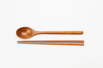 Wooden chopsticks and spoon isolated on white