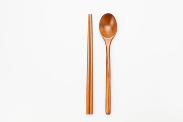 Wooden chopsticks and spoon isolated on white