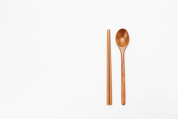 Wooden chopsticks and spoon isolated on white