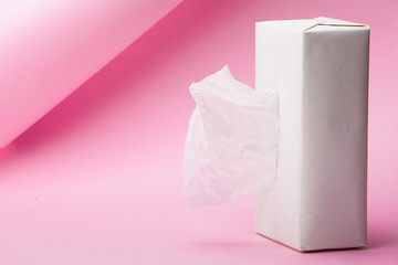 White Tissue box on abstract pink background