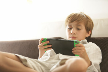 boy, kid, playing games with differen poses and attitudes, gamepad