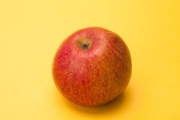  Red apple on yellow background