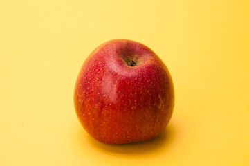  Red apple on yellow background